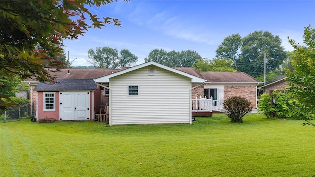 5146 Creek Bend Cir NW, Cleveland, TN 37312 - rear view of house with a storage shed, brick siding, a deck, and a shingled roof