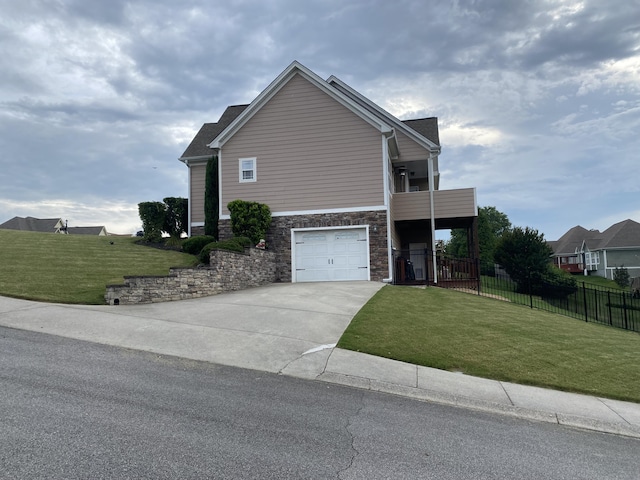 151 Holly Oak Ln, Ringgold, GA 30736 - view of front of house featuring stone siding, driveway, a balcony, and an attached garage