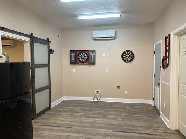 151 Holly Oak Ln, Ringgold, GA 30736 - laundry area with a wall mounted AC, a barn door, and dark wood-style floors