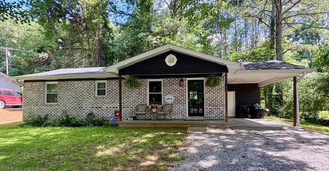 308 Pledger Pkwy, Lafayette, GA 30728 - view of front of home with a carport, gravel driveway, a front yard, and brick siding