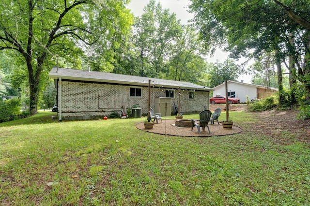 308 Pledger Pkwy, Lafayette, GA 30728 - rear view of house with a fire pit, a yard, and brick siding