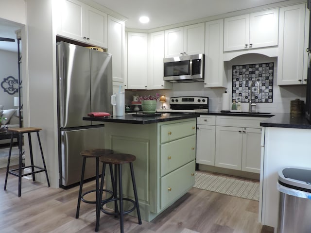 87 Lawrence Dr, Ringgold, GA 30736 - kitchen featuring appliances with stainless steel finishes, a center island, light wood-style flooring, backsplash, and recessed lighting