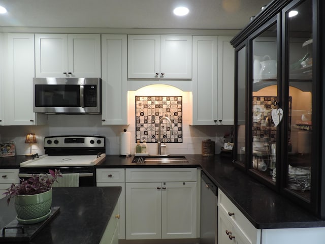 87 Lawrence Dr, Ringgold, GA 30736 - kitchen with appliances with stainless steel finishes, tasteful backsplash, white cabinets, and recessed lighting