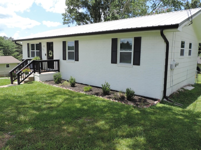 87 Lawrence Dr, Ringgold, GA 30736 - single story home with a front lawn, a metal roof, and brick siding