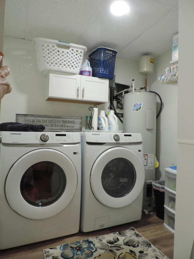 87 Lawrence Dr, Ringgold, GA 30736 - laundry room with cabinet space, water heater, washer and clothes dryer, and wood finished floors