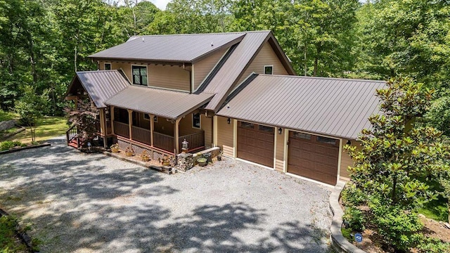 80 Tanya Ln, Dunlap, TN 37327 - rustic home with a porch, gravel driveway, a metal roof, and a garage