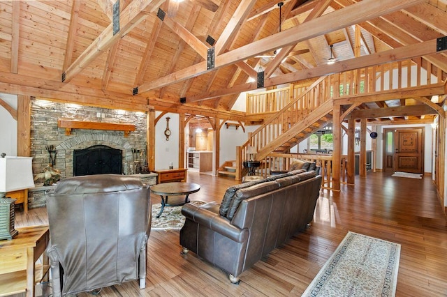 80 Tanya Ln, Dunlap, TN 37327 - living room featuring stairway, high vaulted ceiling, a stone fireplace, a wooden ceiling with exposed beams, and hardwood / wood-style flooring