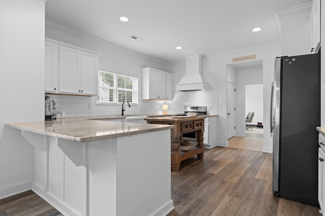3339 Stone Creek Dr, Chattanooga, TN 37405 - kitchen with freestanding refrigerator, custom range hood, a peninsula, white cabinetry, and tasteful backsplash