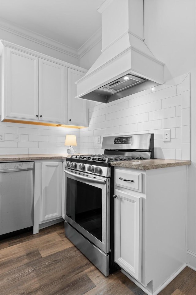3339 Stone Creek Dr, Chattanooga, TN 37405 - kitchen featuring appliances with stainless steel finishes, custom range hood, ornamental molding, white cabinetry, and dark wood-type flooring