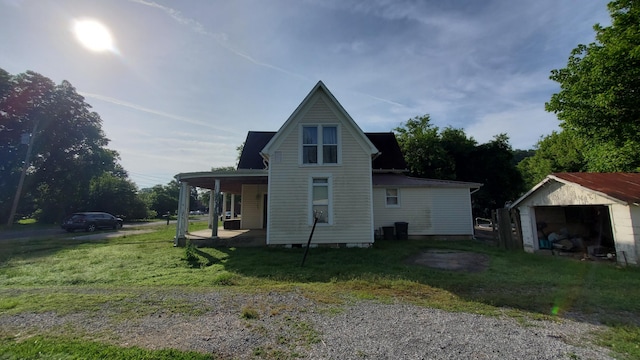 214 E Rhea Ave, Spring City, TN 37381 - view of side of home with a lawn, covered porch, and an outbuilding