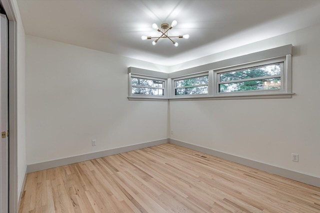 395 Robinson Ln, Decatur, TN 37322 - spare room with a chandelier and light wood finished floors