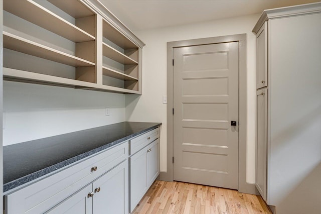 395 Robinson Ln, Decatur, TN 37322 - kitchen with light wood-style flooring, dark countertops, and open shelves