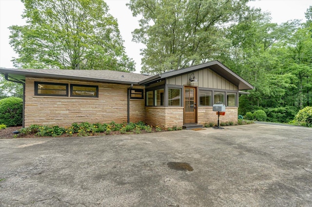 395 Robinson Ln, Decatur, TN 37322 - view of front facade with stone siding, board and batten siding, and asphalt driveway