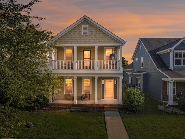 8833 Wilson Creek Dr, Ooltewah, TN 37363 - rear view of house featuring a porch, a yard, and a balcony