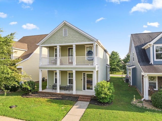 8833 Wilson Creek Dr, Ooltewah, TN 37363 - view of front facade featuring a balcony, a porch, and a front yard