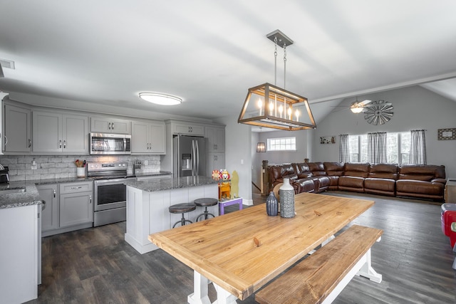 9600 Lovell Rd, Soddy Daisy, TN 37379 - dining area with dark wood finished floors, ceiling fan, and lofted ceiling