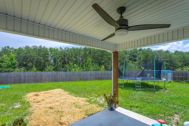 9600 Lovell Rd, Soddy Daisy, TN 37379 - fenced backyard with a trampoline, a patio area, and a ceiling fan