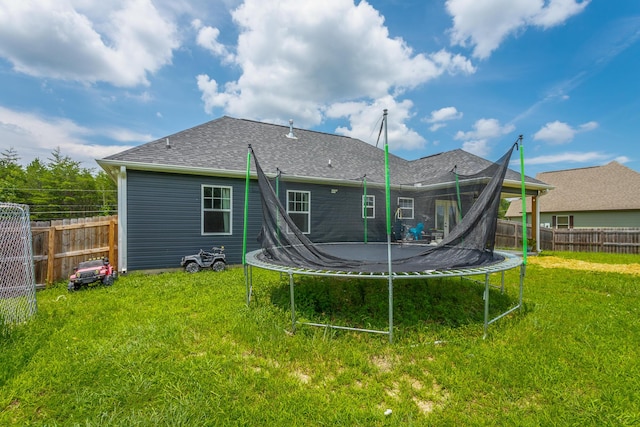 9600 Lovell Rd, Soddy Daisy, TN 37379 - back of property with a trampoline, a fenced backyard, and a shingled roof