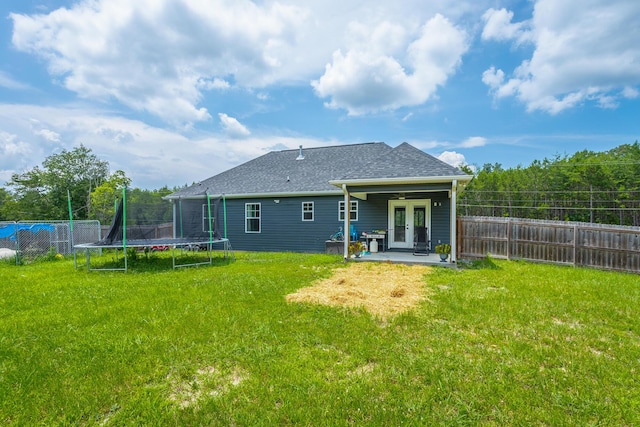 9600 Lovell Rd, Soddy Daisy, TN 37379 - back of property featuring a trampoline, a patio, a fenced backyard, french doors, and a shingled roof