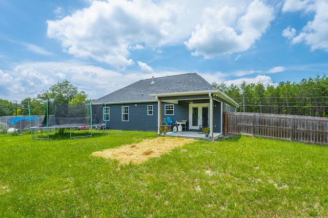 9600 Lovell Rd, Soddy Daisy, TN 37379 - rear view of house featuring a trampoline, french doors, a patio, a fenced backyard, and a shingled roof
