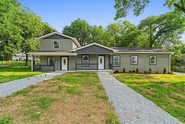 54 Austin Cir, Rossville, GA 30741 - view of front of house with a porch, a front yard, and brick siding