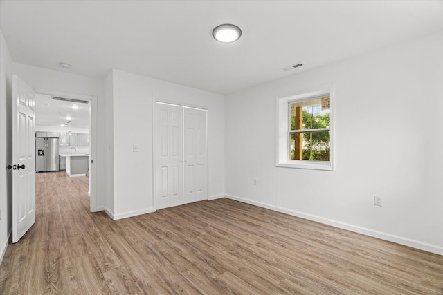 54 Austin Cir, Rossville, GA 30741 - unfurnished bedroom featuring wood finished floors, stainless steel fridge, and a closet