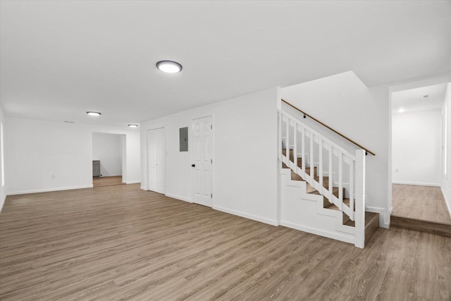 54 Austin Cir, Rossville, GA 30741 - unfurnished living room featuring electric panel, wood finished floors, and stairs