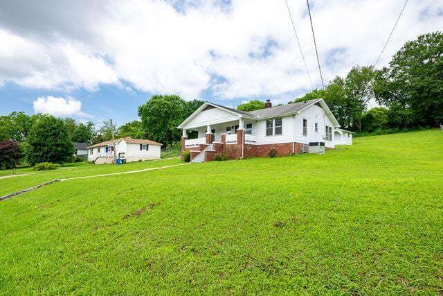 3313 Harrison Pike, Chattanooga, TN 37416 - view of front of home featuring a porch, a front lawn, and a chimney