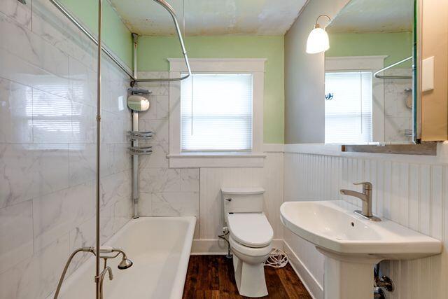 3313 Harrison Pike, Chattanooga, TN 37416 - bathroom featuring wood finished floors, shower / tub combination, and wainscoting