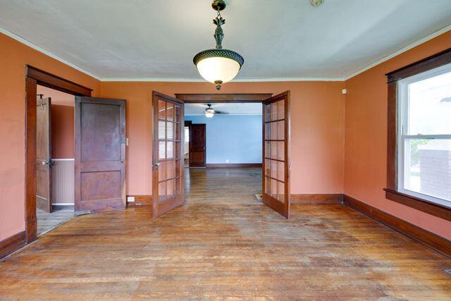 3313 Harrison Pike, Chattanooga, TN 37416 - spare room with french doors, plenty of natural light, wood finished floors, and crown molding