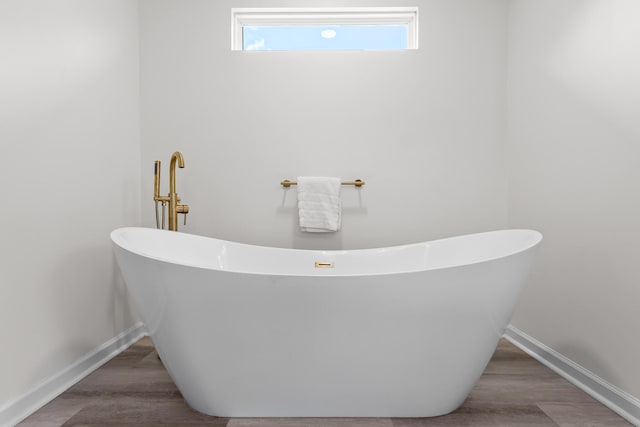 7622 Nadick Ln, Hixson, TN 37343 - bathroom with a soaking tub and wood finished floors