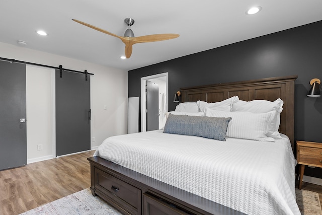 7622 Nadick Ln, Hixson, TN 37343 - bedroom with light wood-type flooring, a barn door, recessed lighting, and ceiling fan