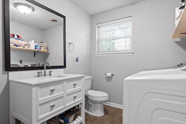7622 Nadick Ln, Hixson, TN 37343 - bathroom featuring washer and dryer, vanity, tile patterned flooring, and a textured ceiling