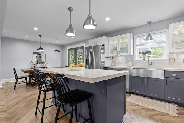 7622 Nadick Ln, Hixson, TN 37343 - kitchen featuring stainless steel fridge, dishwasher, light countertops, a breakfast bar, and healthy amount of natural light