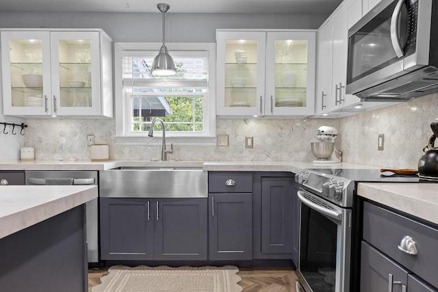 7622 Nadick Ln, Hixson, TN 37343 - kitchen with appliances with stainless steel finishes, light countertops, and white cabinetry