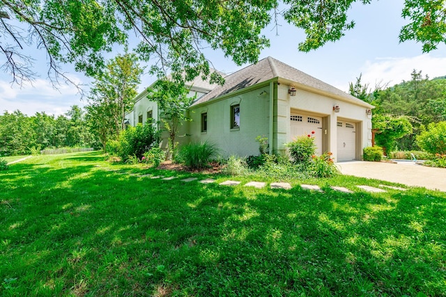 11216 Ooltewah Georgetown Rd, Georgetown, TN 37336 - view of property exterior featuring a lawn, an attached garage, driveway, brick siding, and roof with shingles