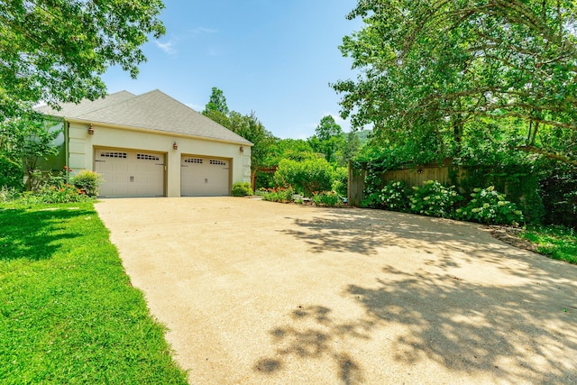 11216 Ooltewah Georgetown Rd, Georgetown, TN 37336 - view of property exterior with driveway, a shingled roof, and stucco siding