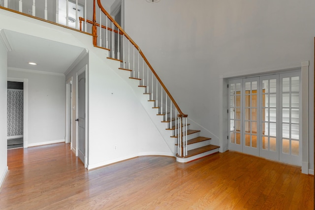 11216 Ooltewah Georgetown Rd, Georgetown, TN 37336 - stairway featuring wood finished floors, crown molding, and a high ceiling