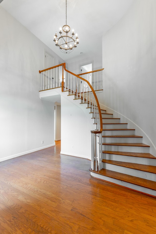11216 Ooltewah Georgetown Rd, Georgetown, TN 37336 - stairway featuring a chandelier, wood finished floors, and a towering ceiling