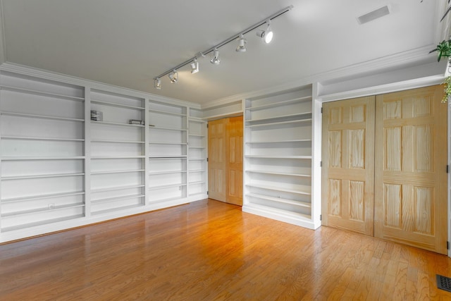 11216 Ooltewah Georgetown Rd, Georgetown, TN 37336 - spare room with rail lighting, wood finished floors, built in shelves, and crown molding