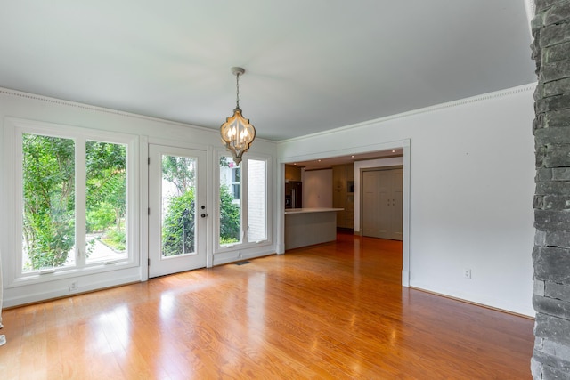 11216 Ooltewah Georgetown Rd, Georgetown, TN 37336 - spare room featuring a chandelier, healthy amount of natural light, wood finished floors, and ornamental molding