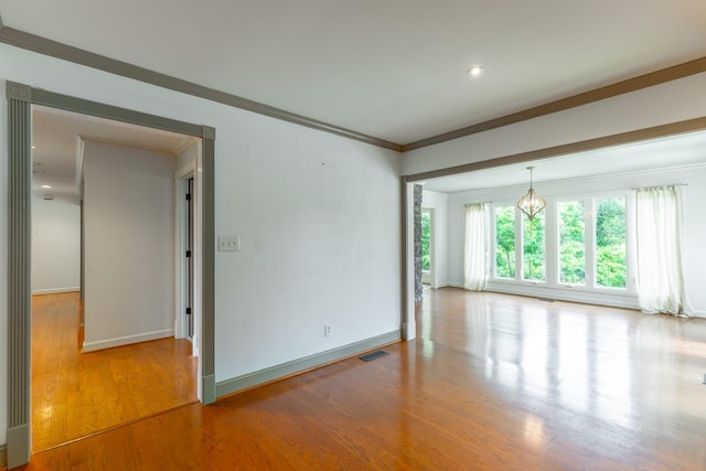 11216 Ooltewah Georgetown Rd, Georgetown, TN 37336 - spare room with wood finished floors, ornamental molding, and a chandelier
