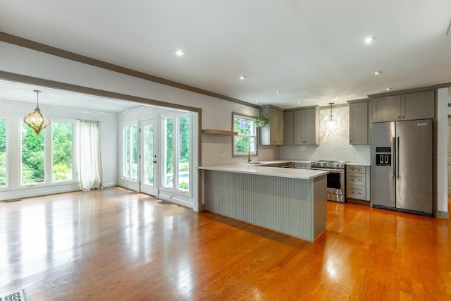 11216 Ooltewah Georgetown Rd, Georgetown, TN 37336 - kitchen featuring stainless steel appliances, light countertops, a peninsula, gray cabinetry, and light wood-type flooring