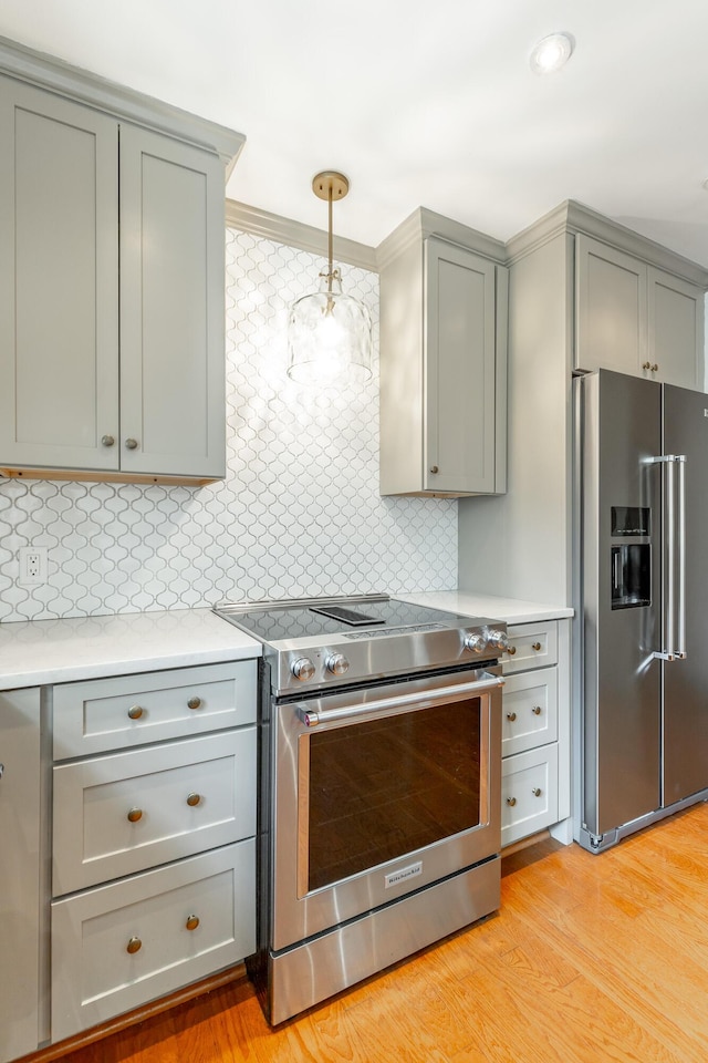 11216 Ooltewah Georgetown Rd, Georgetown, TN 37336 - kitchen featuring appliances with stainless steel finishes, gray cabinetry, decorative backsplash, light countertops, and light wood-style flooring