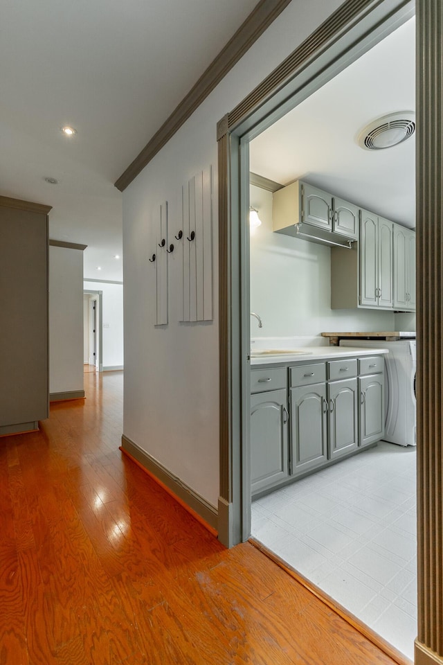 11216 Ooltewah Georgetown Rd, Georgetown, TN 37336 - hall with crown molding, light wood-style flooring, recessed lighting, and washer / dryer