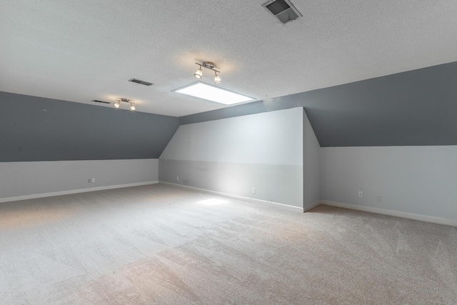 11216 Ooltewah Georgetown Rd, Georgetown, TN 37336 - additional living space with vaulted ceiling, carpet flooring, and a textured ceiling