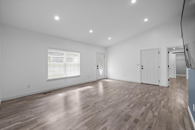 651 Howard Leonard Rd, Ringgold, GA 30736 - unfurnished living room featuring vaulted ceiling, recessed lighting, and wood finished floors