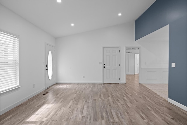 651 Howard Leonard Rd, Ringgold, GA 30736 - unfurnished living room with light wood-type flooring, recessed lighting, a wainscoted wall, and high vaulted ceiling
