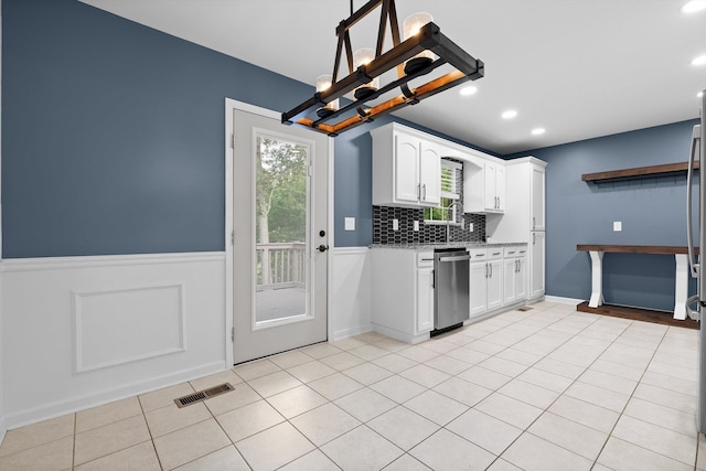 651 Howard Leonard Rd, Ringgold, GA 30736 - kitchen featuring stainless steel dishwasher, a chandelier, white cabinets, wainscoting, and backsplash