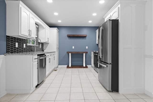 651 Howard Leonard Rd, Ringgold, GA 30736 - kitchen featuring stainless steel appliances, decorative backsplash, recessed lighting, white cabinets, and light stone counters